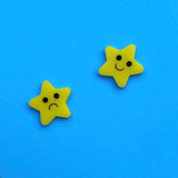 Rounded yellow smiley and sad star earrings